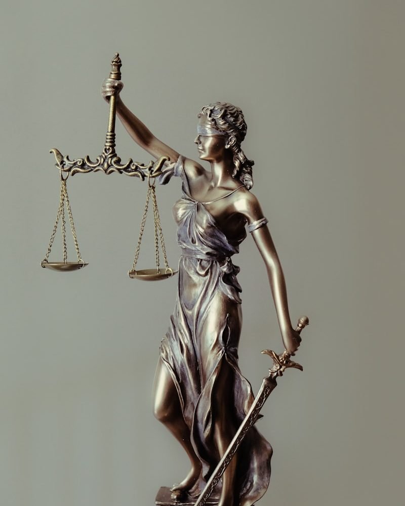 woman in gold dress holding sword figurine